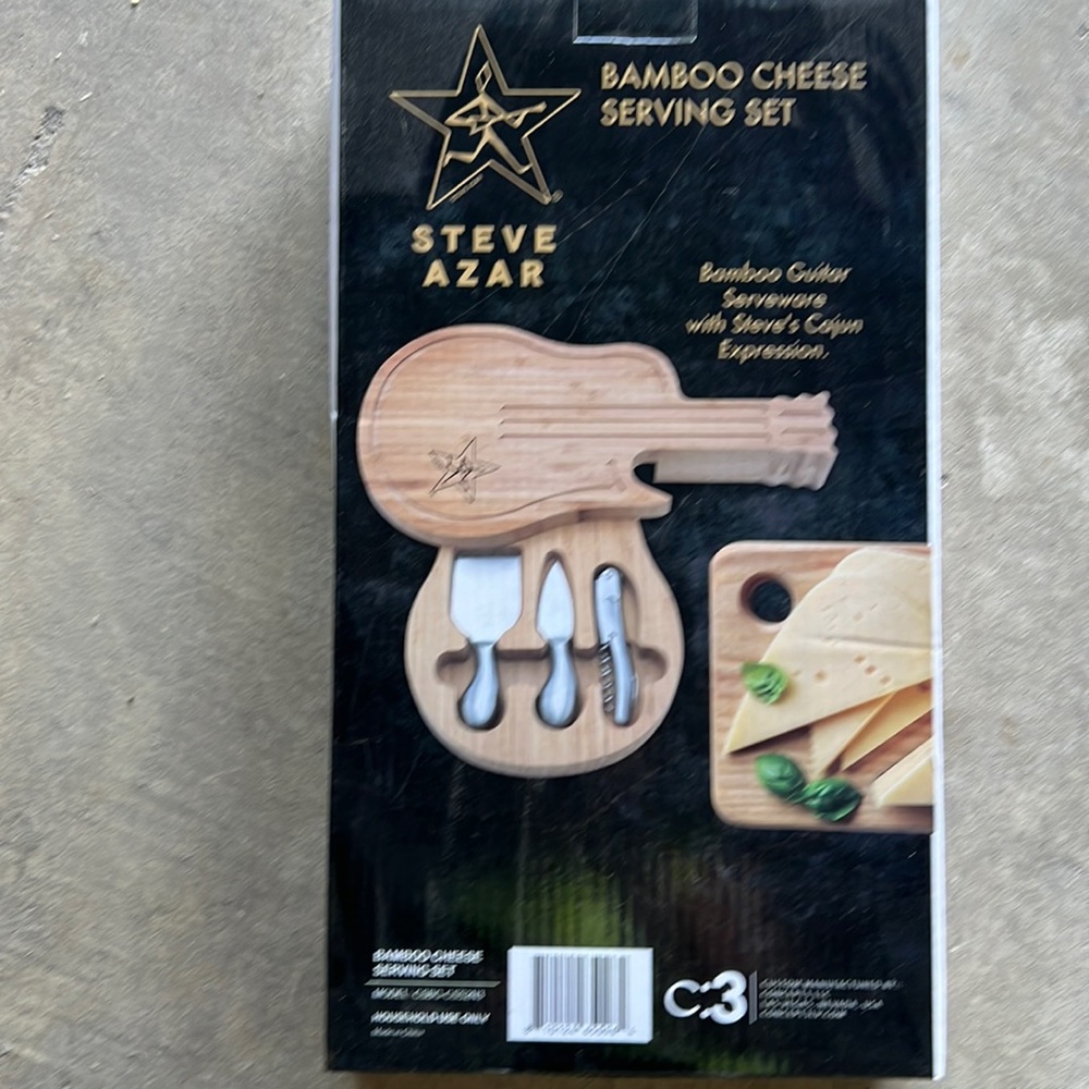 Bamboo guitar serving cheese board with serving wear.